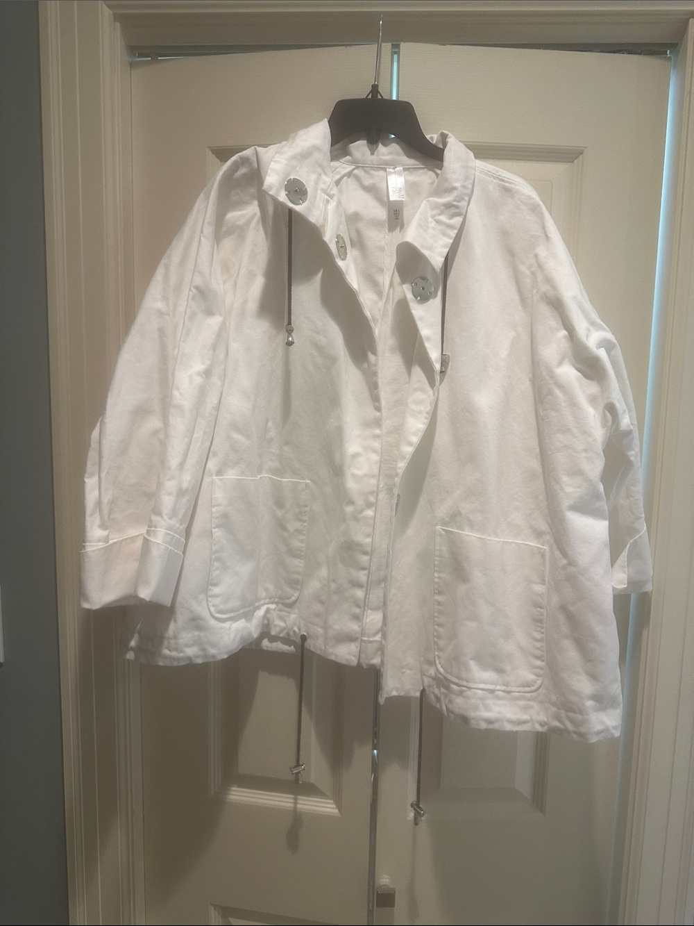 MarlaWynne trench coat with silver snap closure.